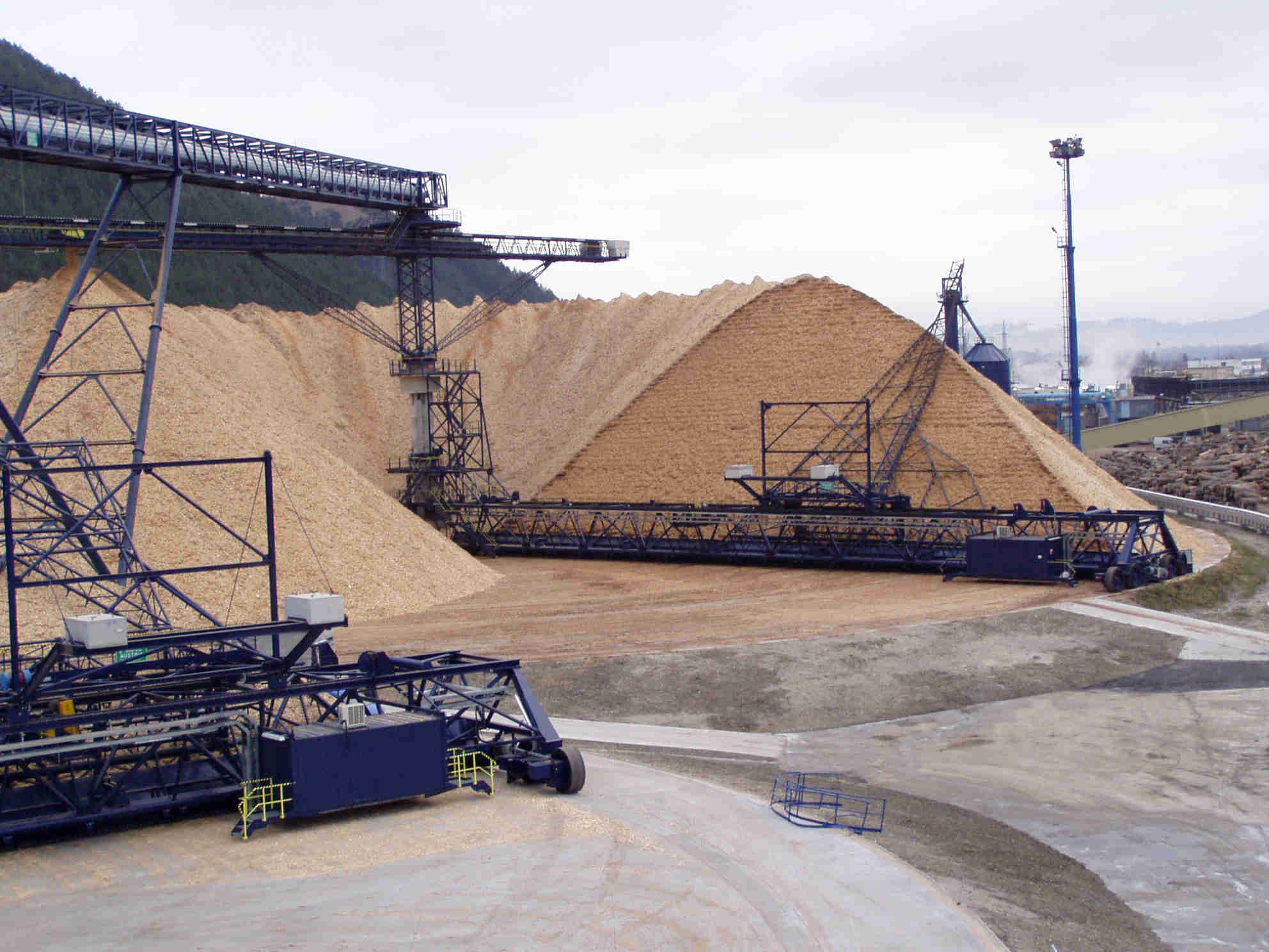 A stacker reclaimer system in action, stacking and reclaiming bulk materials