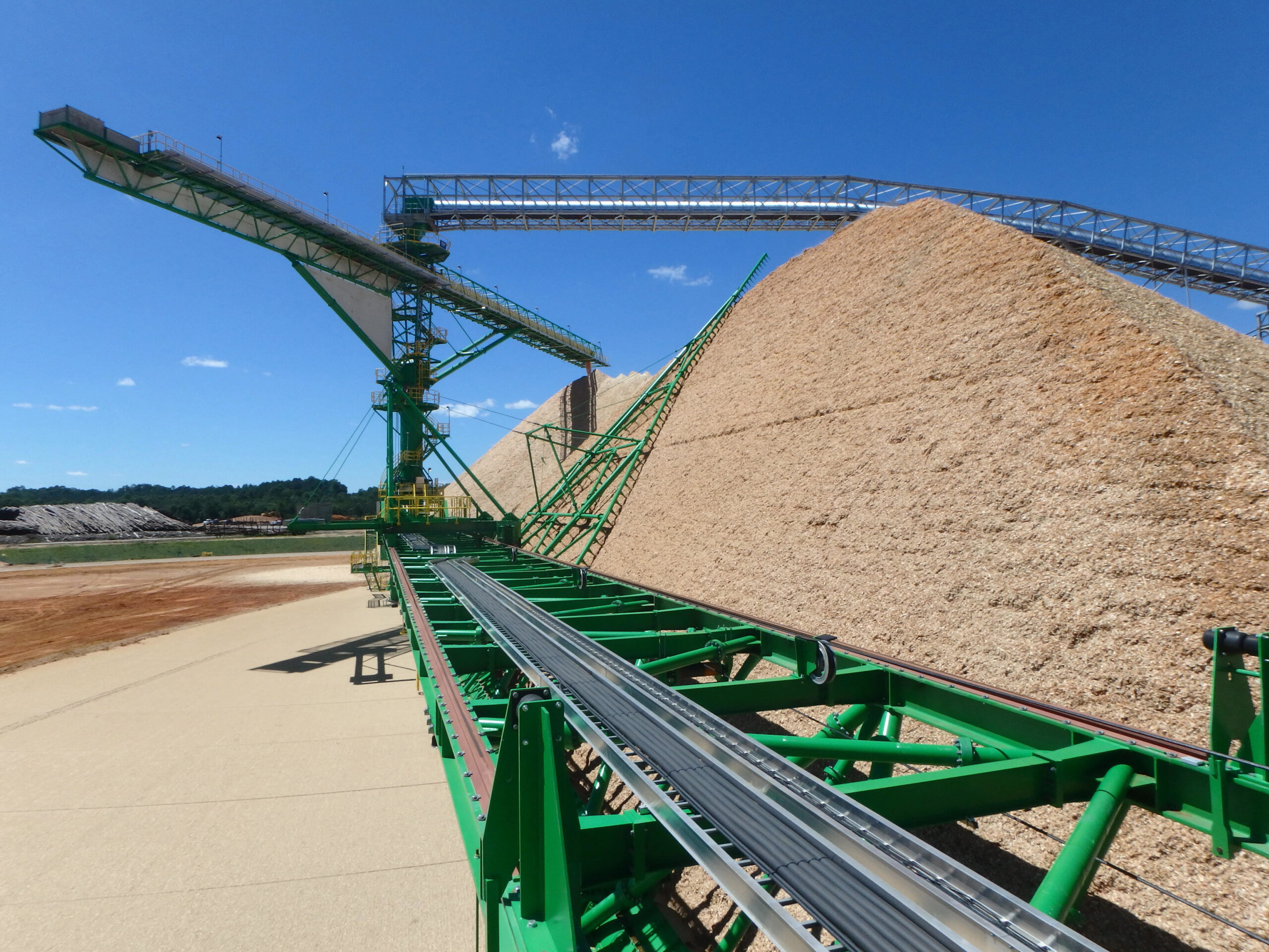 A stacker reclaimer system in action, stacking and reclaiming bulk materials